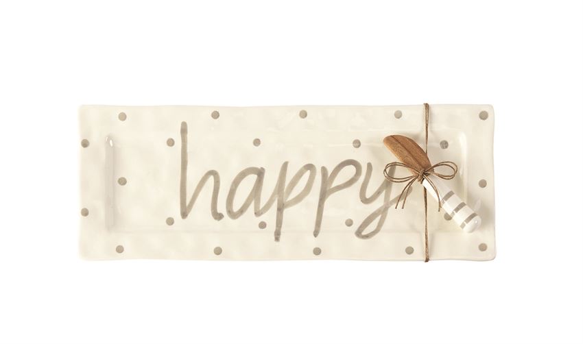 White ceramic platter with gray polka dots and text that says 'happy'.  Coordinating serving knife with wooden plate and striped handle is tied to the platter with twine.