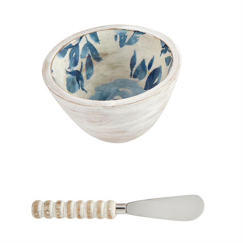White bowl with blue flower interior and a spreader with a white wood bead handle 