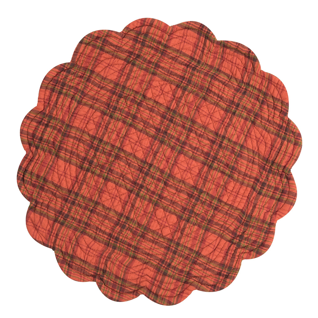 A round placemat with scalloped edges on a white background.  The placemat is a green, brown, and red plaid on a rust orange background.