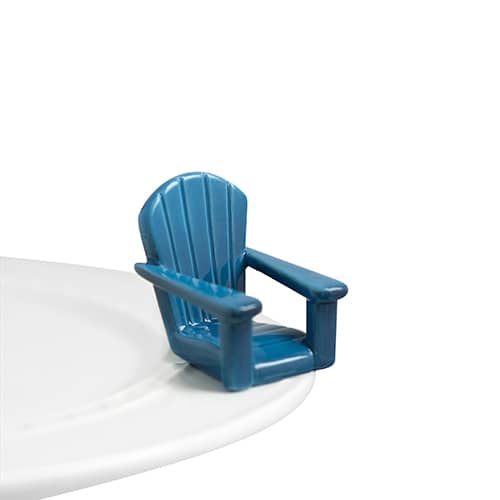 A ceramic blue adirondack chair attached to the edge of a tray.