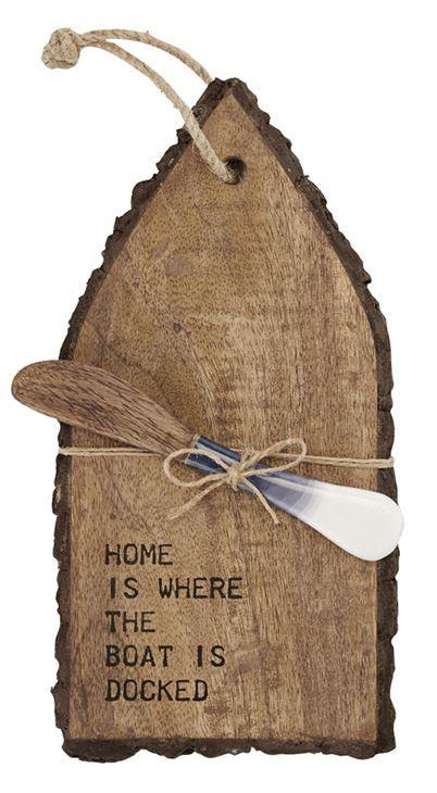 Mini serving board shaped like a boat from above.  Features a spreader tied to the board with twine.  'Home is where the boat is docked' is burnished in to the surface of the board.