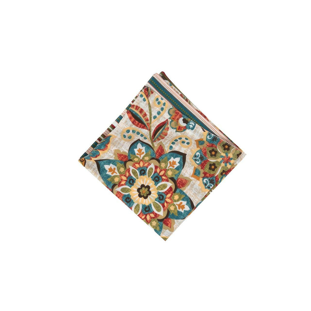 A square folded napkin on a white background.  The pattern is of flowers and leaves in hues of ochre, tomato, blue, green and brown.  