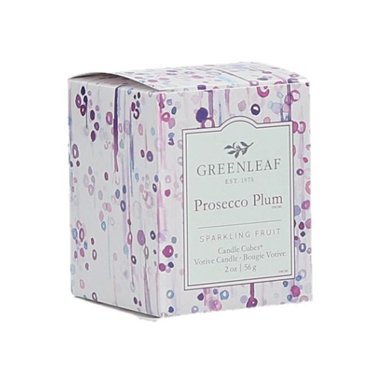 An image of a box with a votive candle inside.  The background is of purple, pink and gray dots, looking similar to bubbles in a champagne glass.  Some have streaks coming down from them, some are solid, others have an open white circle in the middle.  The center of the box has a label that reads 'Greenleaf Est. 1975 Prosecco Plum Sparkling Fruit Candle Cubes, Votive Candle'