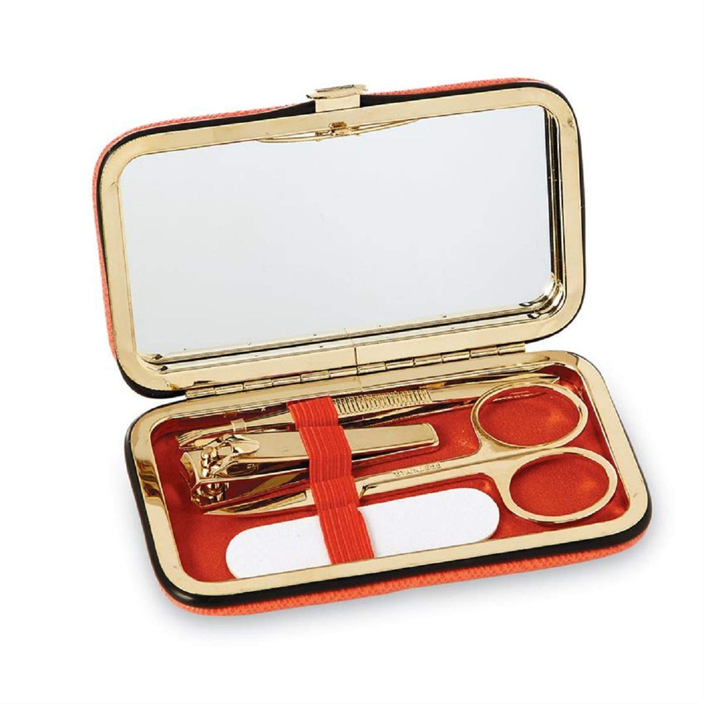 inside of 5 piece manicure kit, mirror, tweezers, scissors, nail clippers, emery board resting on red fabric