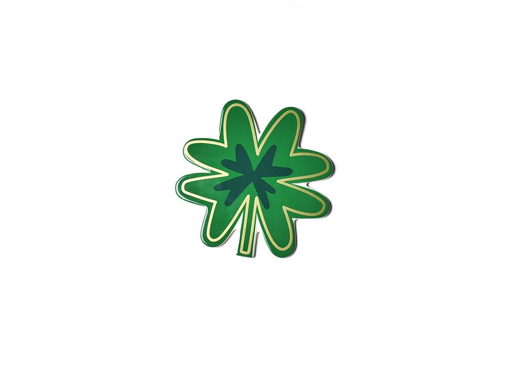 A flat ceramic cut out of a four leaf clover.  Overall the item is kelly green, with a smaller 4 leaf clover in the middle in dark green.  The entire item is outlined with a shimmering gold line.