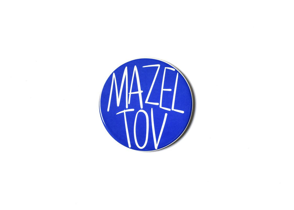 A flat round ceramic circle that says 'Mazel Tov' in all capital white letters on a blue background.