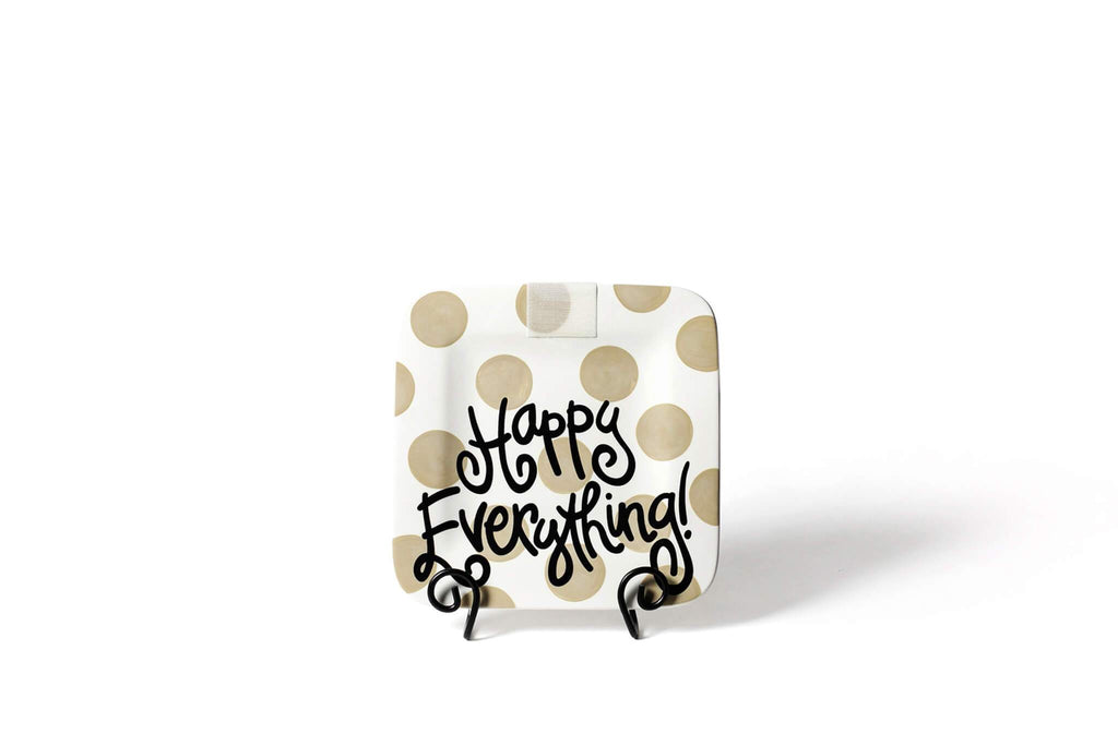 A square platter on a black plate stand.  The corners of the platter are rounded and the platter has an overall white background and tan large polka dot pattern.  Written across the bottom half of the platter is 'Happy Everything!' in black.