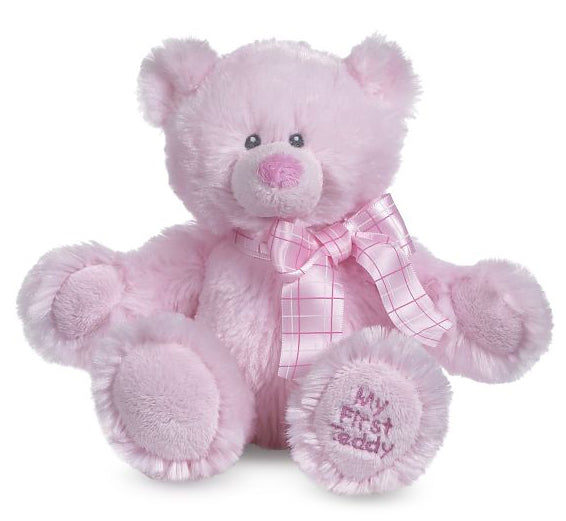Pink stuffed teddy bear with a pink plaid satin bow around its neck.  Embroidered on the right foot is 'My First Teddy'