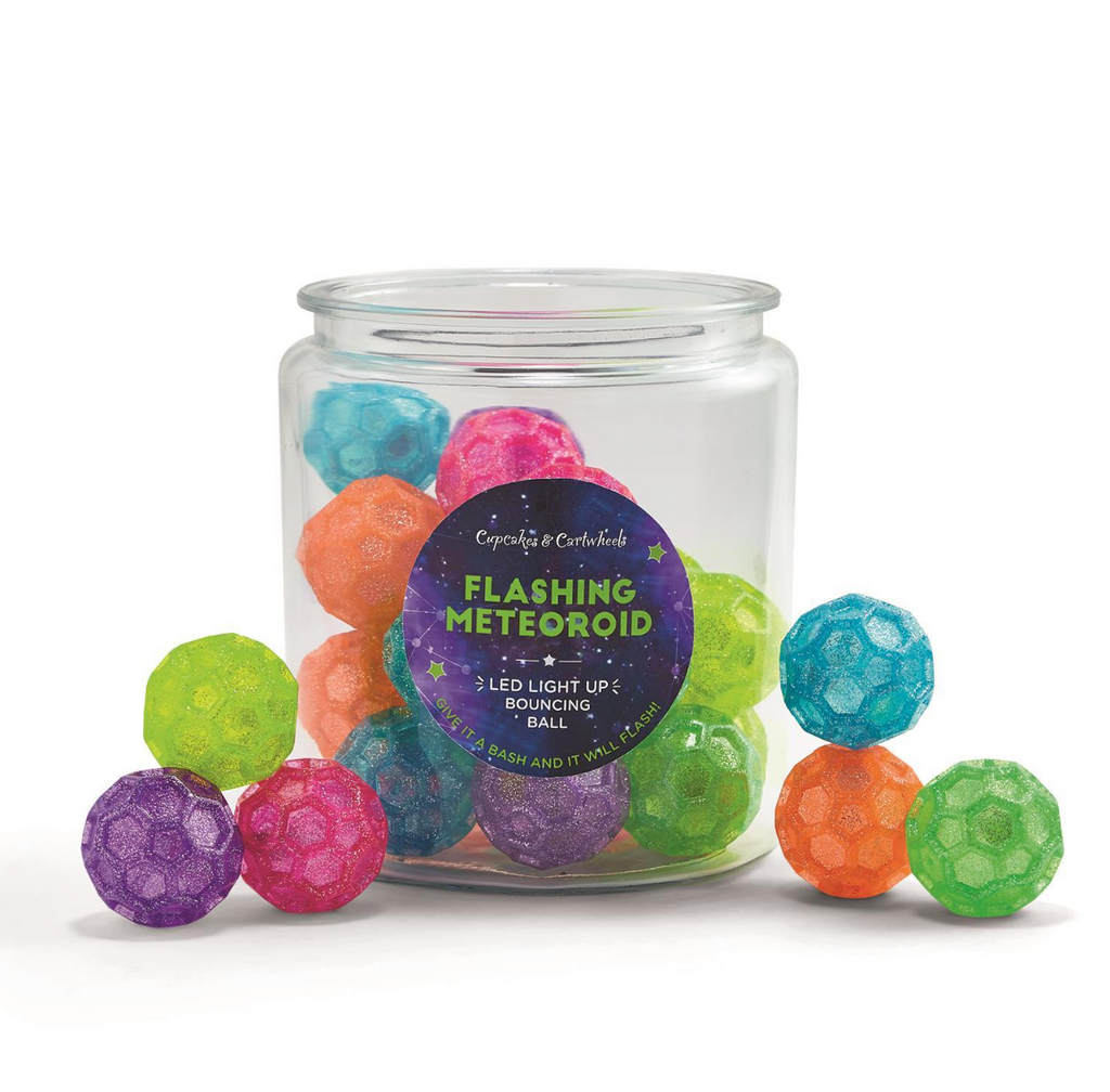 A clear container filled with translucent balls with hexagonal details.  The balls are arranged in and outside of the jar and are in a multitude of colors such as lime green, purple, pink, blue, orange and grass green.