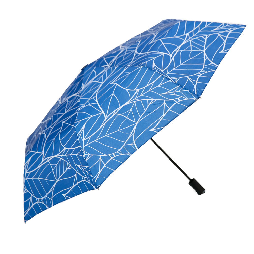 An open umbrella with a navy and light blue pattern of leaves.