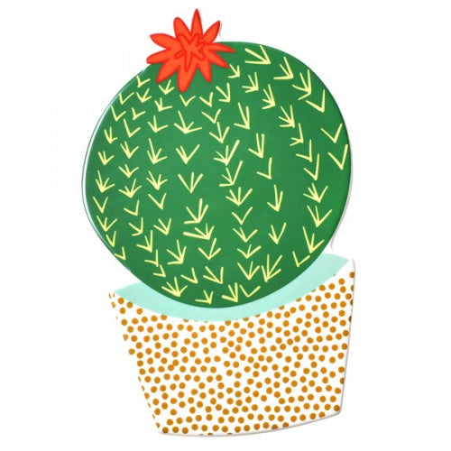 A flat ceramic cactus in a white pot with a gold overall pattern on it.  The cactus itself is round and green with yellow Vs to show pricks.  The top of the cactus has a red flower.
