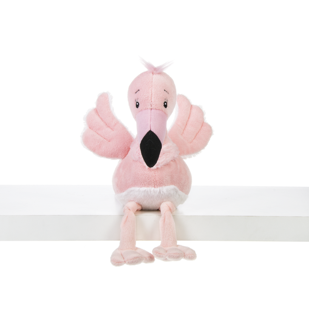 A plush pink flamingo sitting on a shelf with its legs dangling off the side.