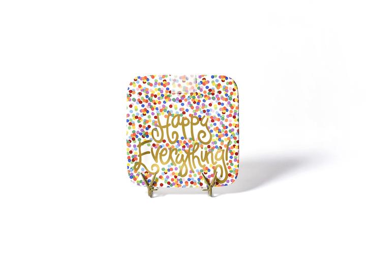 A square plate with printed confetti over the entire surface.  Happy Everything is written in gold script across the plate.  A piece of clear velcro is positioned above the text to receive add on pieces.