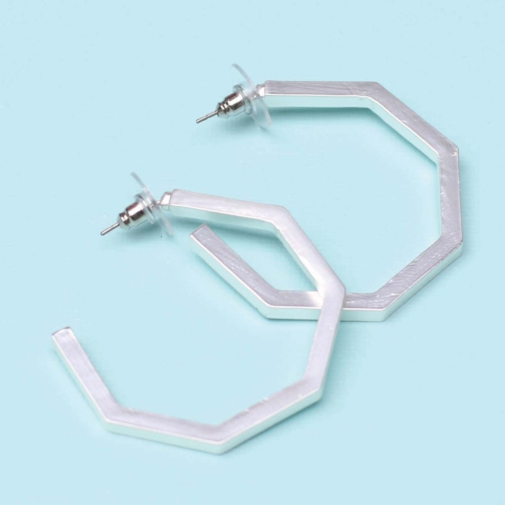 A pair of matte silver hoop earrings that are octagons instead of circles.  