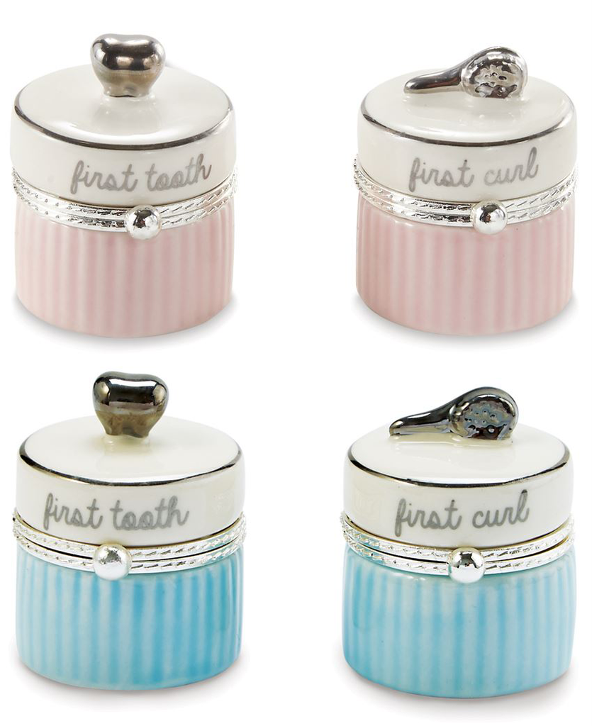 A photo of four small ceramic containers.  The top row features a pair that has alternating pink and dark pink stripes below the clasp, and above it state in script 'first tooth' and 'first curl'.  The left container has a silver tooth on top, and the right container has a silver brush.  The bottom row features the same pair of containers, but the stripes are blue and dark blue.