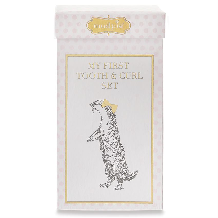 My First Tooth & Curl Set gift box exterior.  Features metallic gold 'mudpie' logo, a gold frame around an image of an otter with a gold bow in its hair.  The box also features a pink polka dot print.