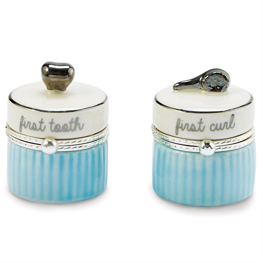 2-piece set. Ceramic tooth and curl keepsake boxes feature silverplate tooth and brush toppers.  The lid is off white with a silver ring around the top, script on the side of the top says 'first tooth' and 'first curl'.  The bottom is alternating vertical blue lines.