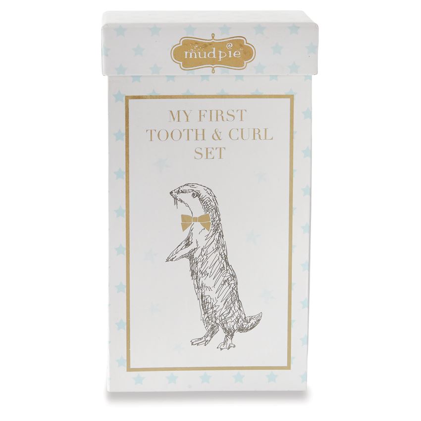 My First Tooth & Curl Set gift box exterior.  Features metallic gold 'mudpie' logo, a gold frame around an image of an otter with a gold bow on its neck  The box also features a blue polka dot star print.