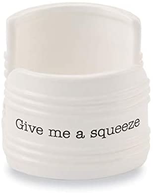 White ceramic sponge holder with black de-bossed text that says "give me a squeeze"