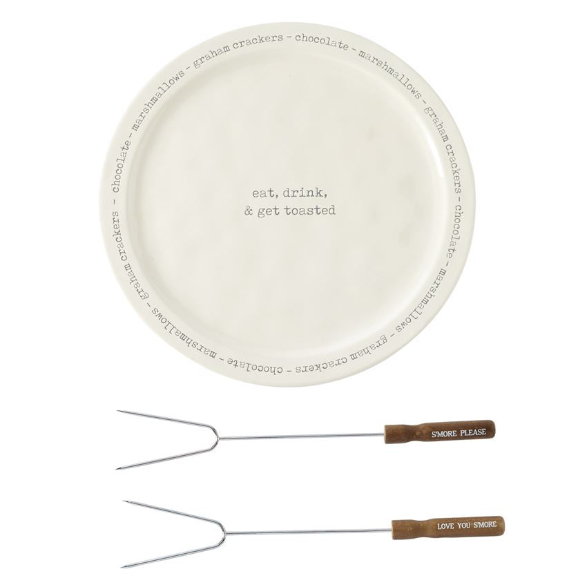 White platter with black embossed text in the middle that says 'eat, drink, & get toasted' .  Additional repeating text around the rim of the platter says 'graham crackers - chocolate - marshmallows'.  Below the platter are two skewers.  White text on the handles of the skewer says 'Smore Please' and 'Love you Smore'