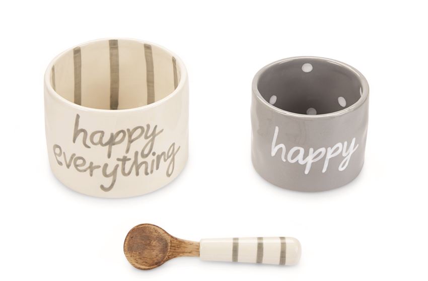 Ceramic bowl set with coordinating spoon.  White bowl says 'happy everything' on the outside, and has matching gray vertical stripes on the inside.  Gray bowl is slightly smaller and says 'happy' on the outside, with matching white polka dots in the inside.  