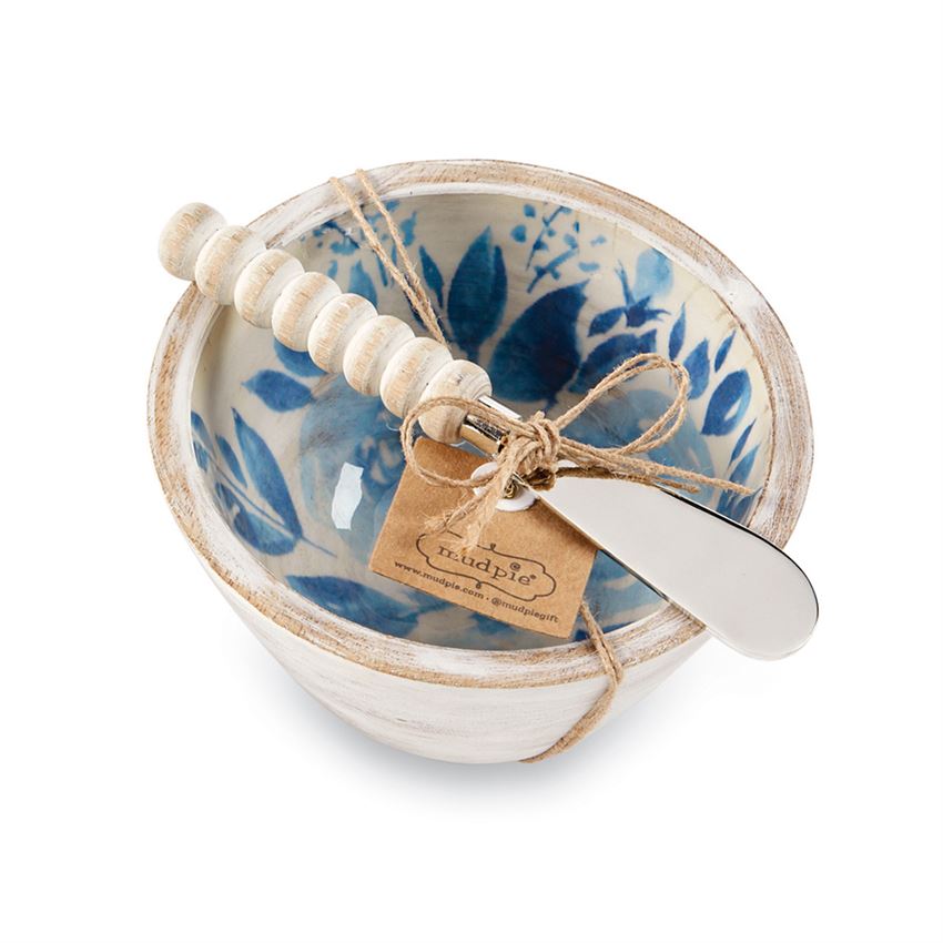 White bowl with blue flower interior and a spreader with a white wood bead handle tied together with twine