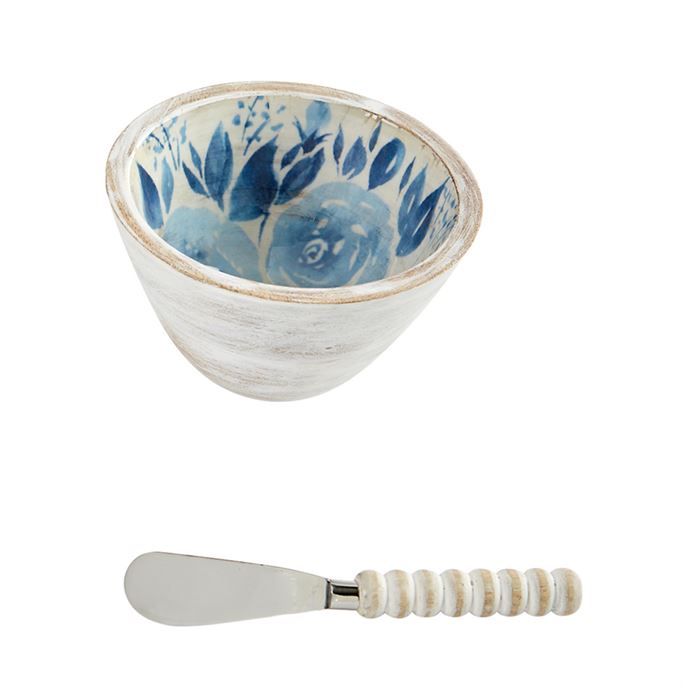 White bowl with blue flower interior and a spreader with a white wood bead handle 