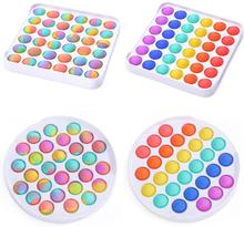 A collection of 4 popper toys.  The top two are both squares.  The left features multi color tie-dye poppers, and the right are solid colors in a rainbow orientation.  Below are two circular popper trays, with the left being tie dye and the right rainbow.