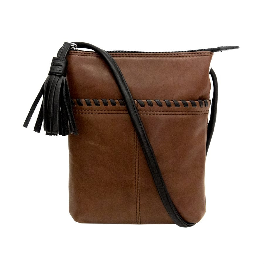A brown leather crossbody purse with a black strap positioned diagonally across it.  The zippered enclosure on the top has a black fringed tassel attached.  The exterior pocket features a black leather whipstitched embellishment along the top.