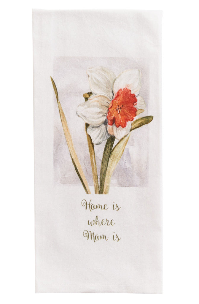 An image of a white kitchen towel with a printed image of a white flower with red center above the text 'Home is where Mom is'