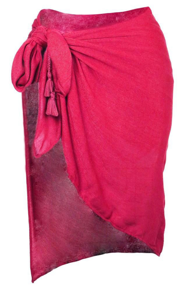 Pink sarong tied to the side with a knot and a tassel.
