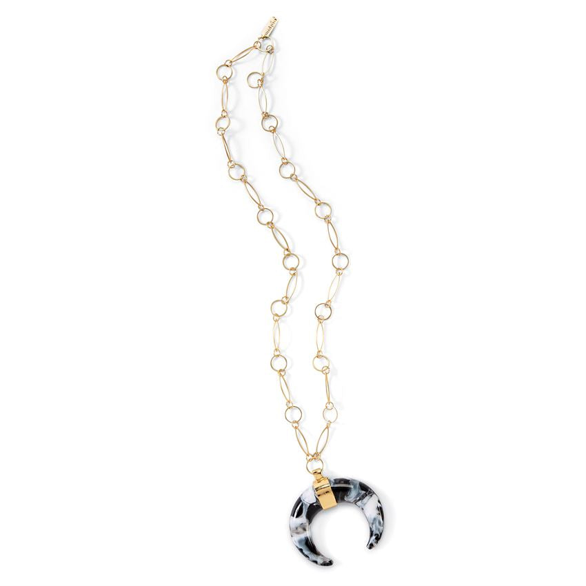 Black and white crescent shaped pendant on a long gold chain