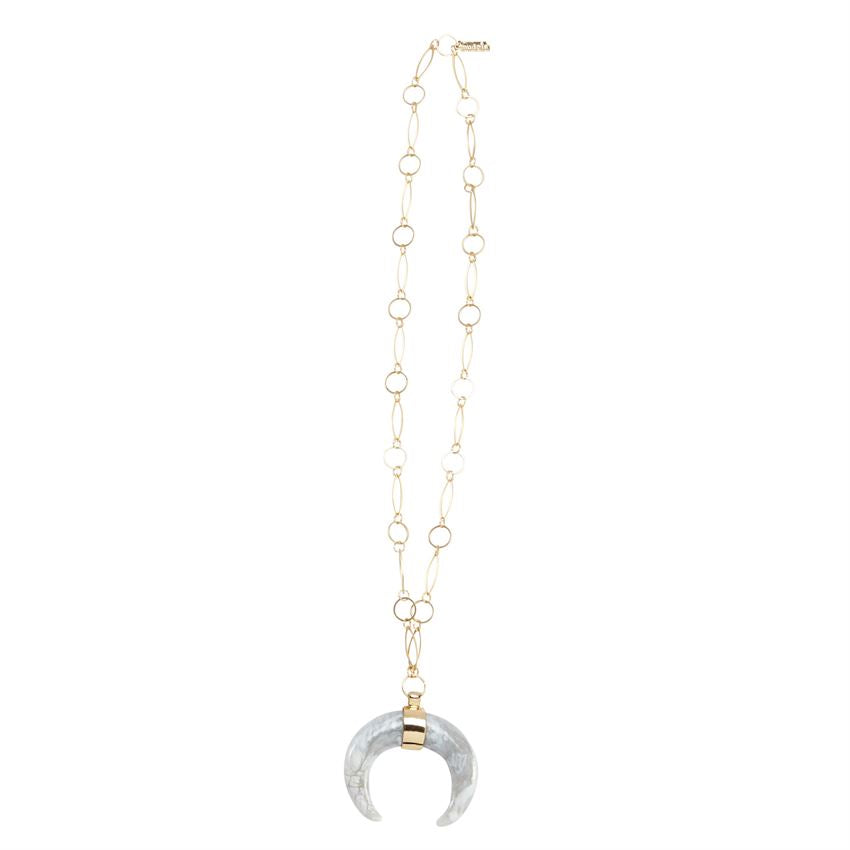 White crescent shaped pendant on a long gold chain