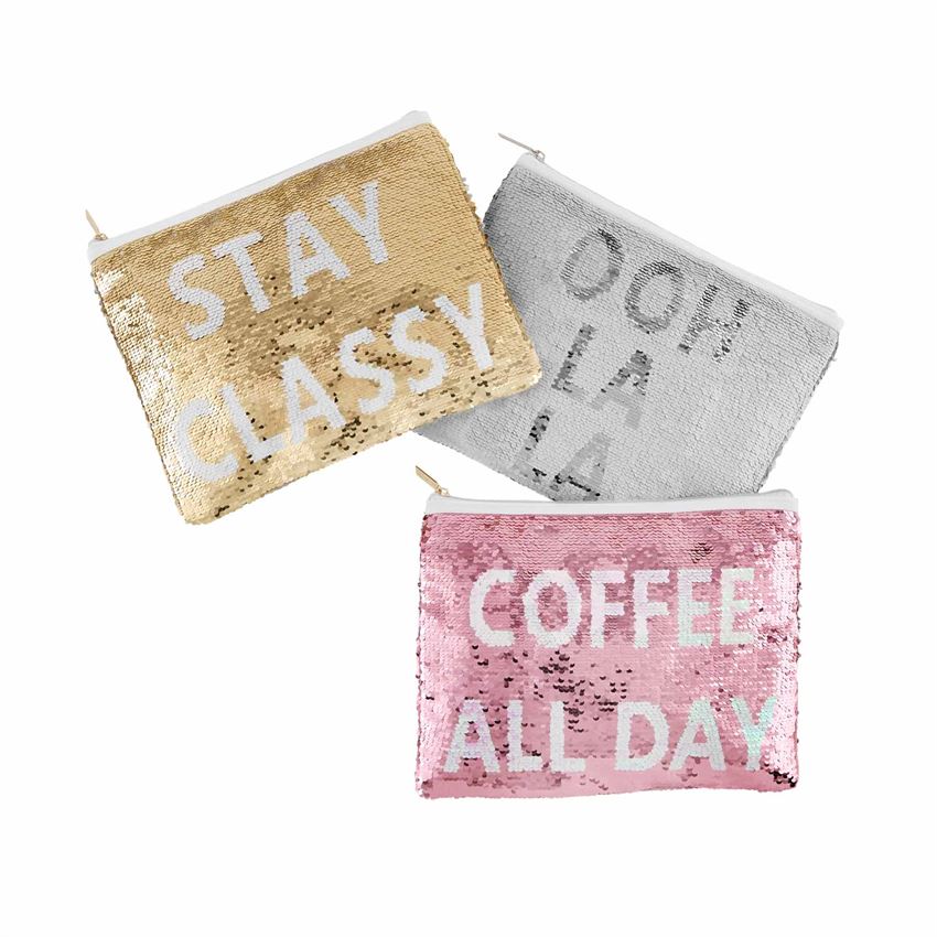 Three sequined cases, each with a top zip enclosure.  The left one says, 'stay classy' in white text on a gold background.  The next one says 'ooh la la' in dark silver text on a white background.  The bottom one says 'coffee all day' in white text on a pink background.