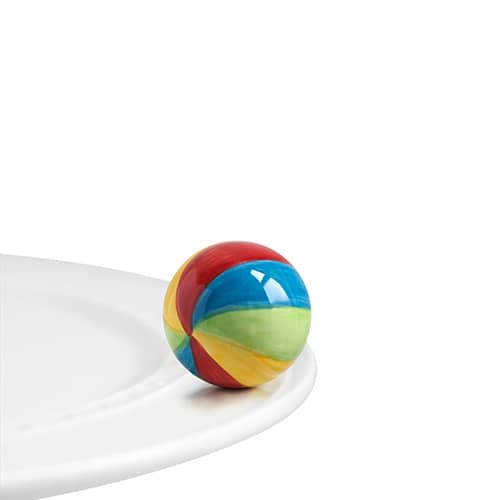 A sphere painted to look like a colorful beach ball attached to the edge of a tray.