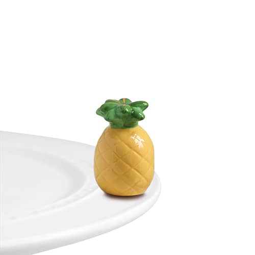 A ceramic pineapple attached to a tray.