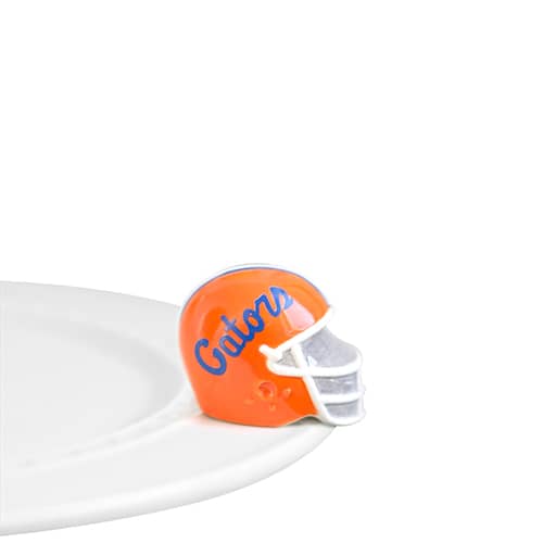 A ceramic orange football helmet, with "Gators" in blue painted on the side, attached to the edge of a tray.