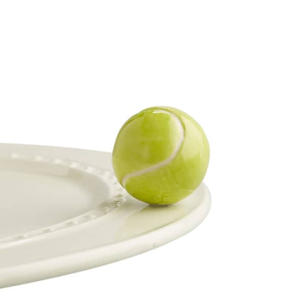 A ceramic sphere painted to look like a tennis ball attached to the edge of a tray.