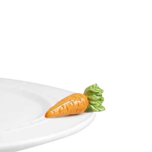 A ceramic carrot attached to the edge of a tray.