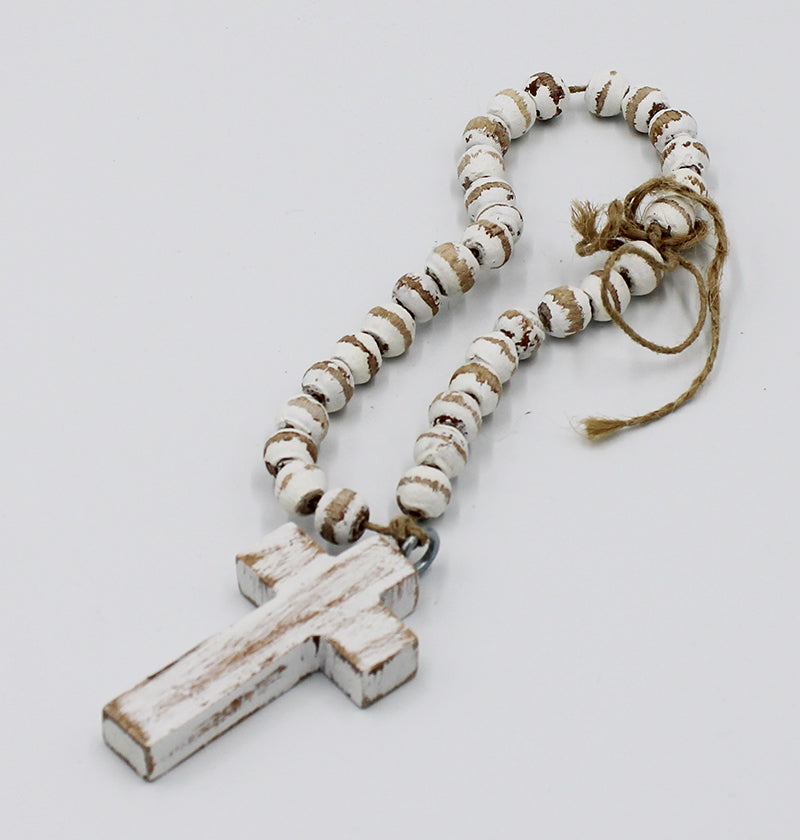 A short closed loop of white wooden beads with a wooden cross, and twine loop for hanging.