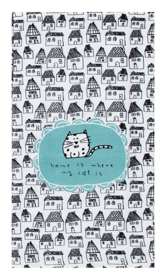 A kitchen towel with a background of drawn houses.  On top of the houses is a blue oval with scalloped edges.  In the oval is a drawing of a cat and below it is the text 'home is where my cat is'
