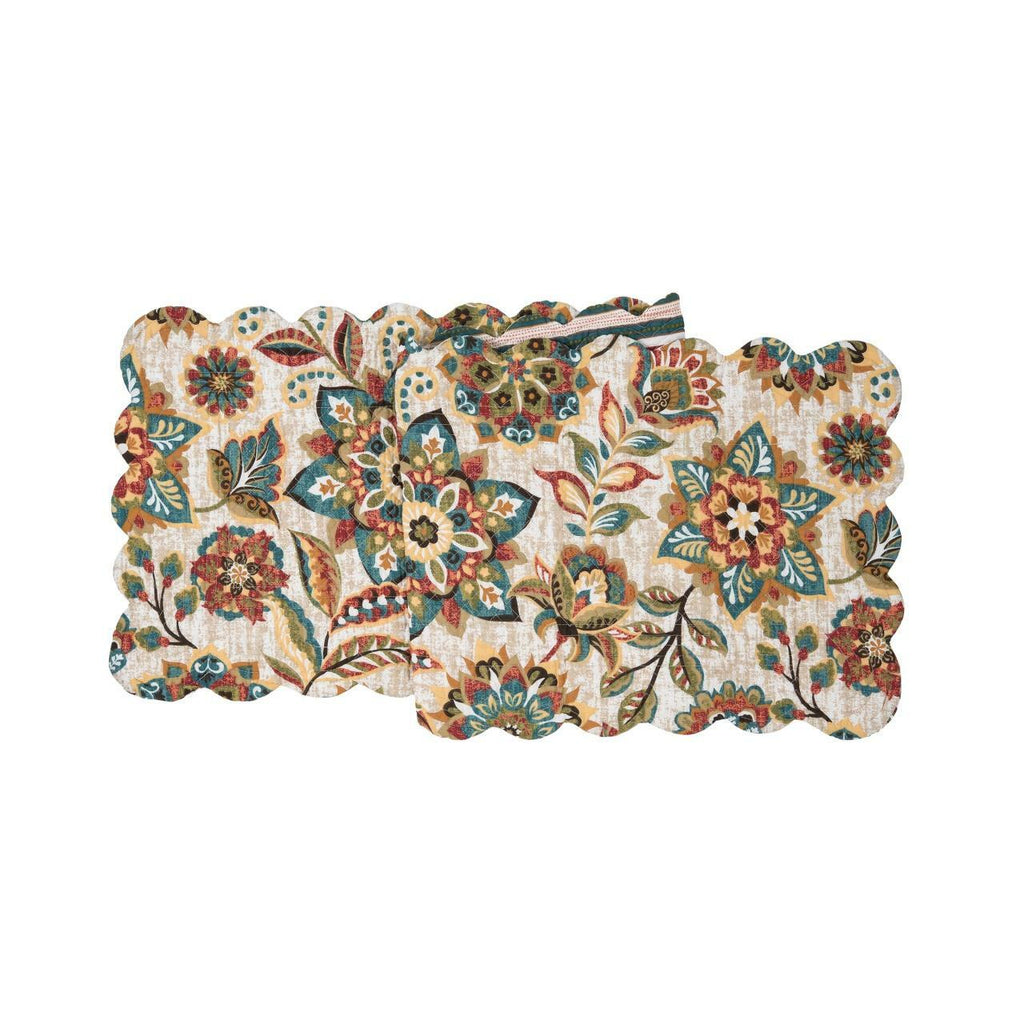 A rectangular scalloped quilted runner on a white background.  The pattern is of flowers and leaves in hues of ochre, tomato, blue, green and brown.  