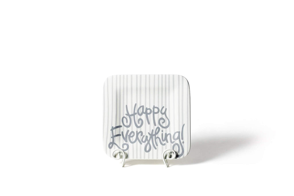 A square platter on a white plate stand.  The corners of the platter are rounded and the platter has an overall gray and white vertical stripe pattern.  Written across the bottom half of the platter is 'Happy Everything!' in silver.