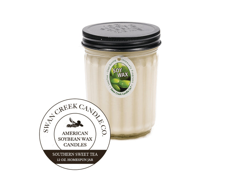 An image of a candle in a glass jar with a black lid.  The candle is white.  A graphic seal in front of the candle says 'Swan Creek Candle Co. American Soybean Wax Candles Southern Sweet Tea 12 oz. Homespun Jar'.  The candle also has an ovular white label attached by a string wrapped under the lid.  The label has an image of green soybeans and says 'Soy Wax' along with 'Lead Free, intensely fragrant, clean burning'