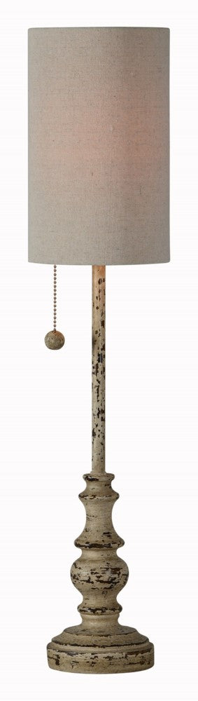 A buffet lamp with a cylindrical shade and a pull string to turn it on.  The lamp is tan with a distressed finish exposing dark tones underneath.