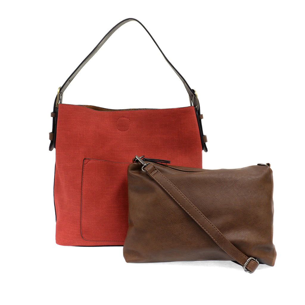 Red faux linen hobo bag with brown buckle strap, and accompanying brown insert bag with cross body strap.