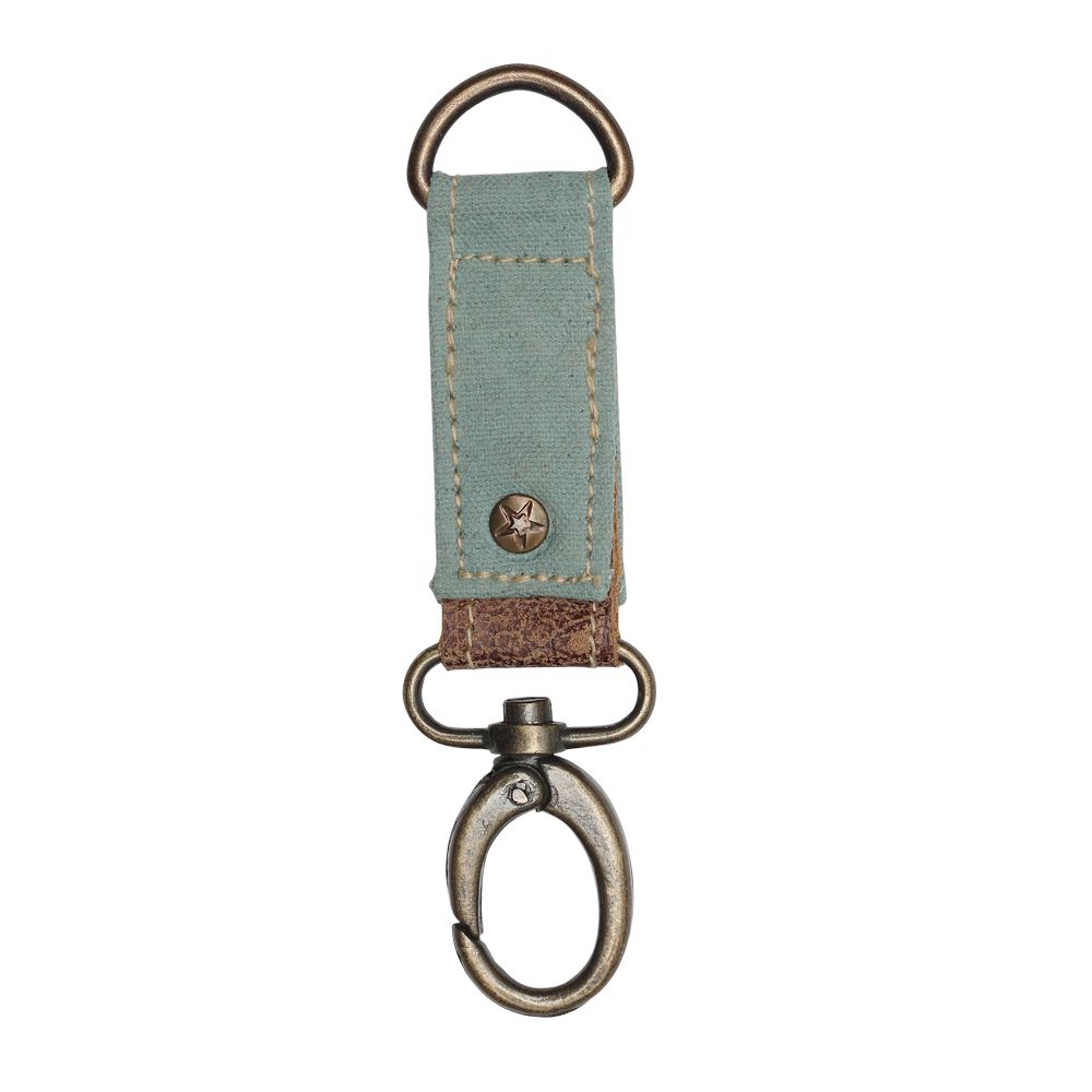 Canvas key fob with brass details, leather accent, and a rivet with a star embossed.  The canvas color is turquoise.