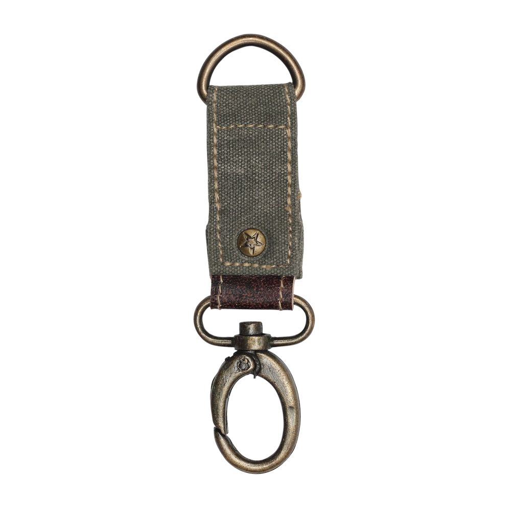 Canvas key fob with brass details, leather accent, and a rivet with a star embossed.  The canvas color is sage green.
