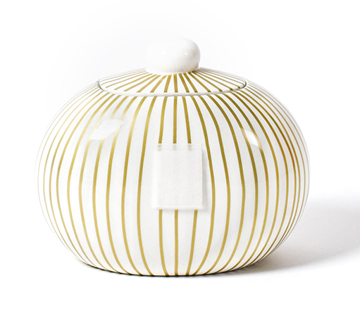 A round cookie jar on a white background.  The outside of the jar is white with gold vertical stripes that extend onto the lid.  The lid is topped with a spherical white orb.  The front of the jar has a large piece of velcro on it to receive decorative attachments.