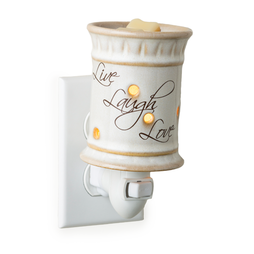 Ceramic cylinder candle warmer plugged into an outlet.  Live Laugh Love is written on the side in a cursive script.